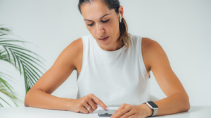 A woman sitting operating a mobile phone